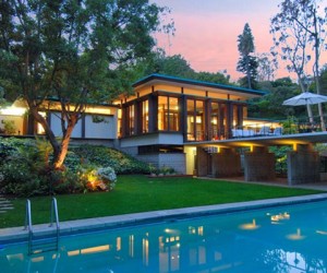 Towering ceilings and walls of glass overlooking private terraces, verdant gardens an...