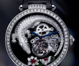 The Crocodile on the black dial is curled around, almost protecting, a flying tourbil...
